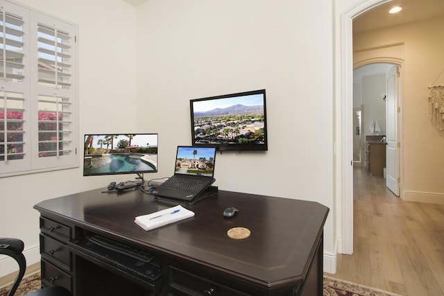 office area with light hardwood / wood-style floors