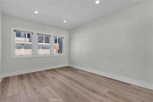 spare room with light hardwood / wood-style floors