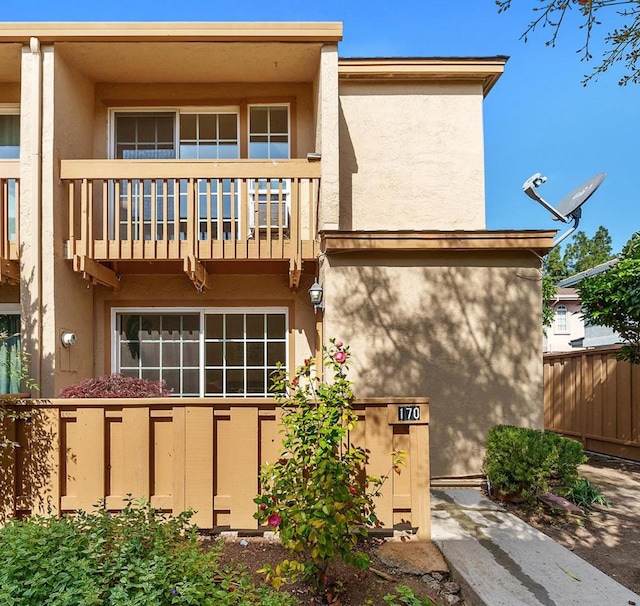 back of property featuring a balcony