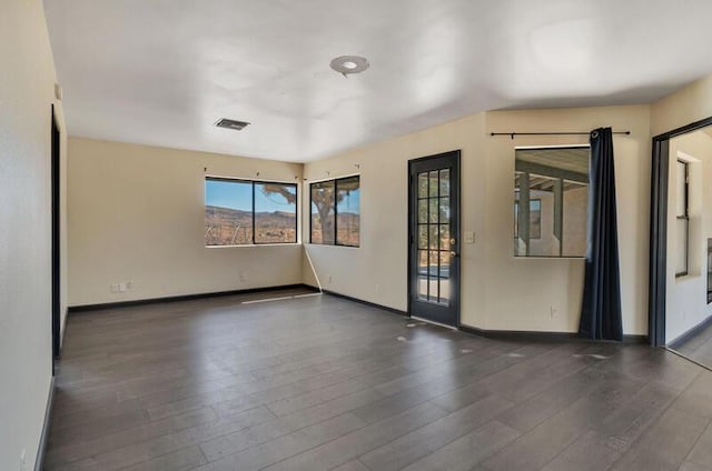 unfurnished room featuring dark hardwood / wood-style flooring