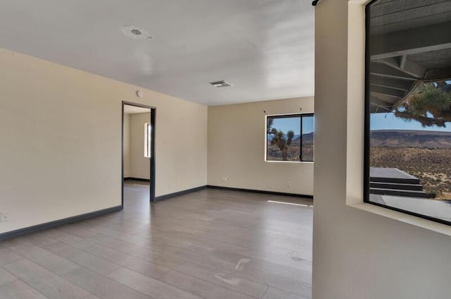 spare room with light hardwood / wood-style floors