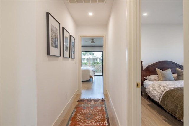 hallway with light hardwood / wood-style flooring