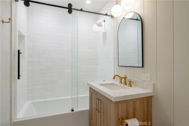 bathroom with vanity and bath / shower combo with glass door