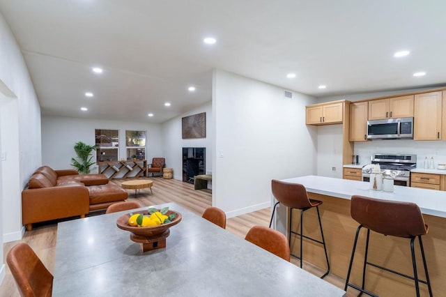 dining area with light hardwood / wood-style floors