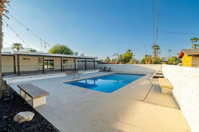 view of swimming pool with a patio