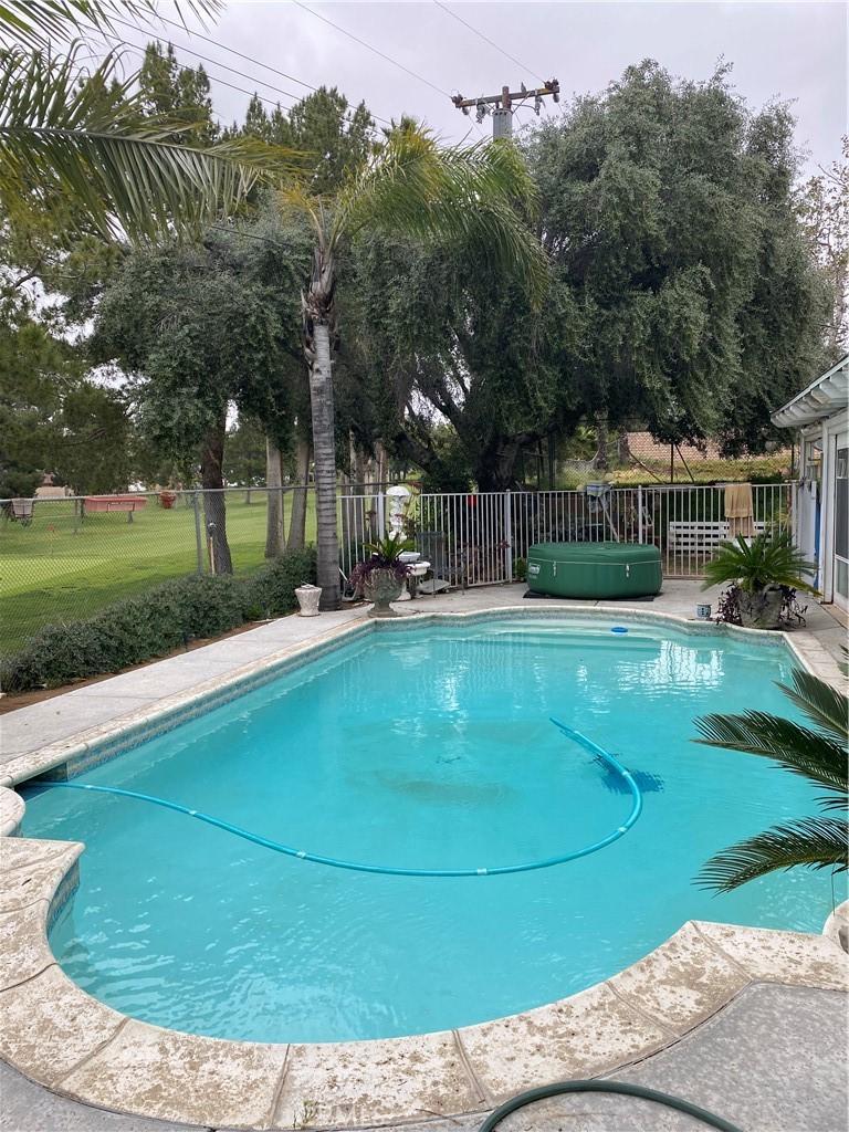 view of swimming pool featuring a hot tub