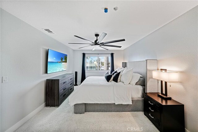 bedroom with ceiling fan and light carpet