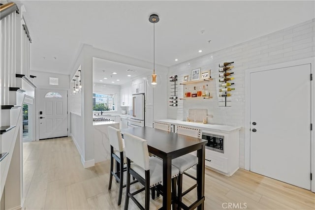 dining space featuring sink and light wood-type flooring