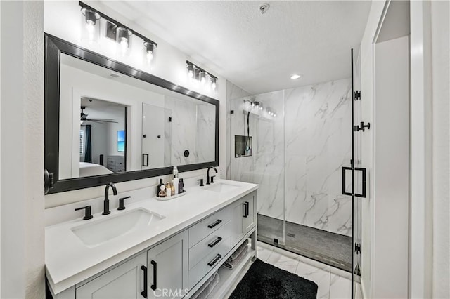 bathroom with a shower with door and vanity