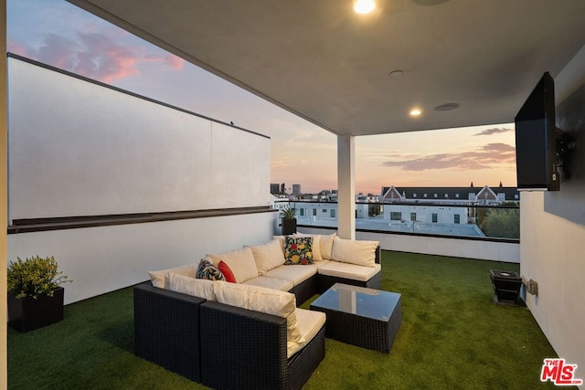 patio terrace at dusk with an outdoor hangout area and a yard