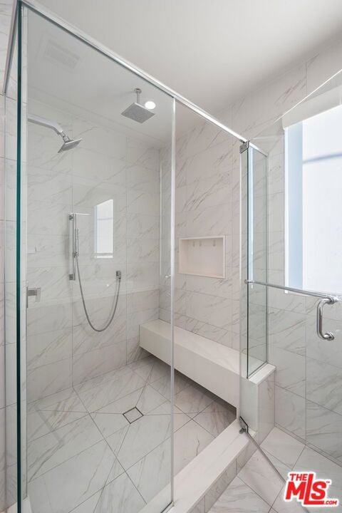 bathroom with a shower with door