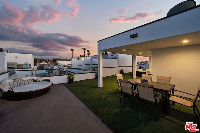 patio terrace at dusk with a lawn