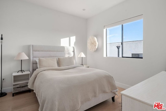 bedroom with hardwood / wood-style floors