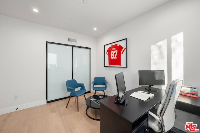 office space with light hardwood / wood-style flooring