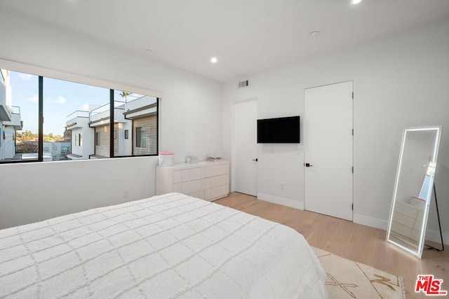 bedroom with light hardwood / wood-style flooring