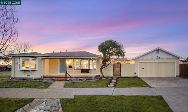 ranch-style house featuring a garage and a yard