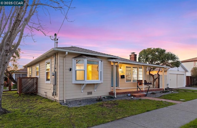 bungalow with a porch and a yard