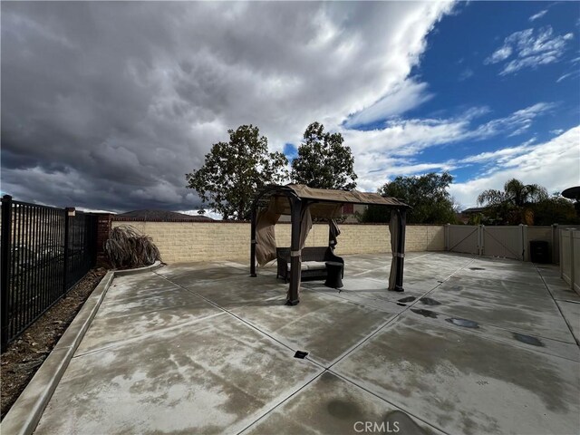 view of patio / terrace with a gazebo and a fenced backyard