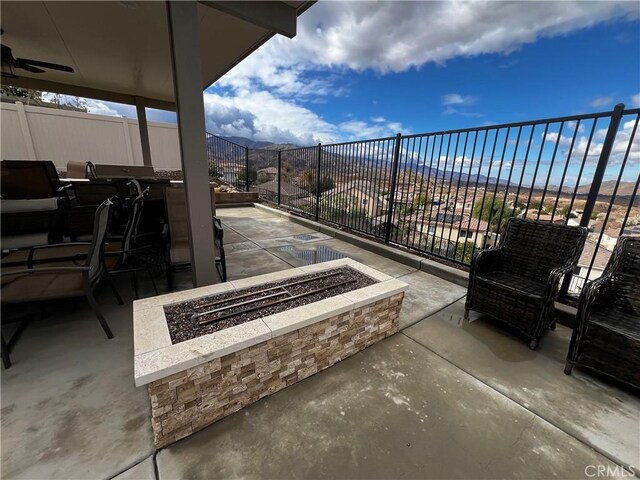 view of patio / terrace featuring an outdoor fire pit and fence