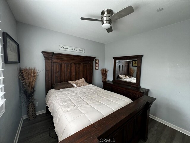 bedroom featuring a ceiling fan, dark wood finished floors, and baseboards