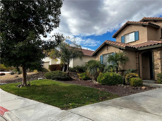 mediterranean / spanish house with a front yard