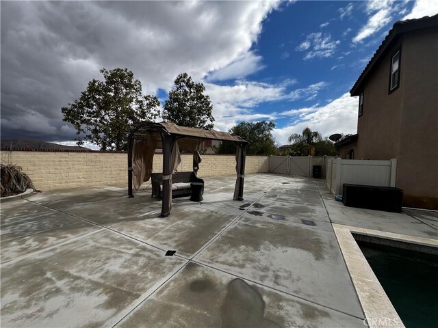 view of patio with a gazebo and a fenced backyard