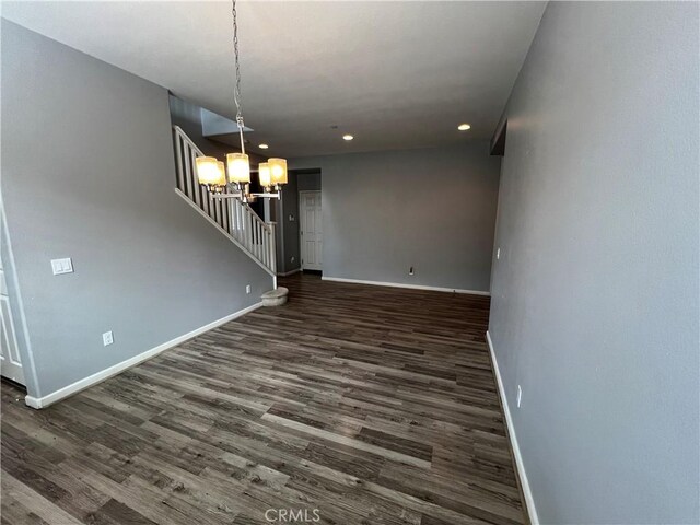 interior space featuring baseboards, dark wood-style flooring, stairs, a notable chandelier, and recessed lighting