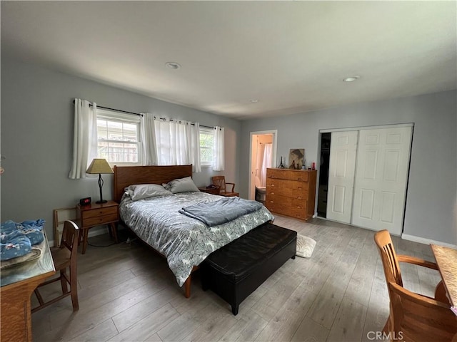 bedroom featuring a closet and light wood-type flooring