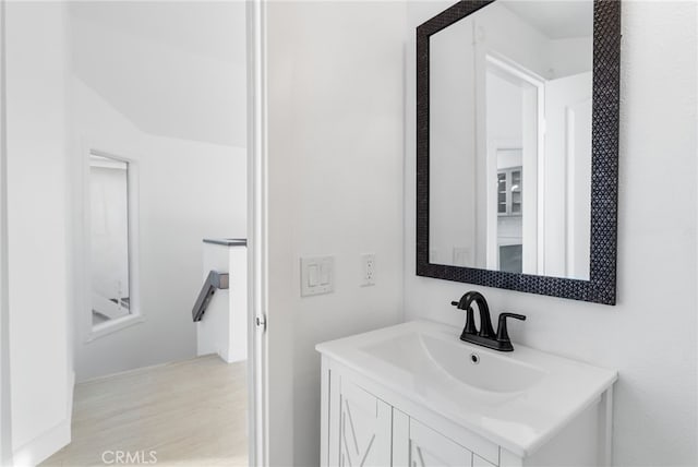 bathroom featuring hardwood / wood-style flooring and vanity