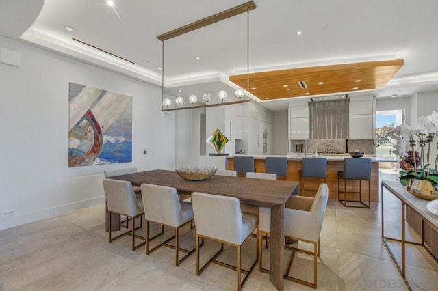 dining area featuring a raised ceiling