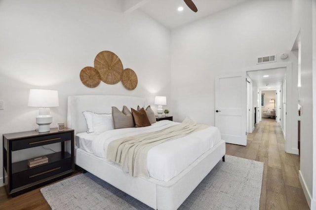 bedroom featuring wood-type flooring, ceiling fan, and high vaulted ceiling