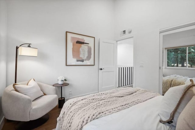 bedroom with dark hardwood / wood-style flooring