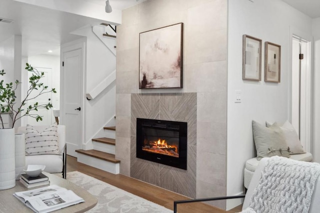 living room with hardwood / wood-style floors and a fireplace