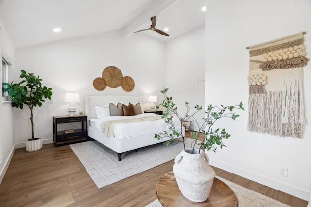 bedroom featuring lofted ceiling with beams, wood-type flooring, and ceiling fan