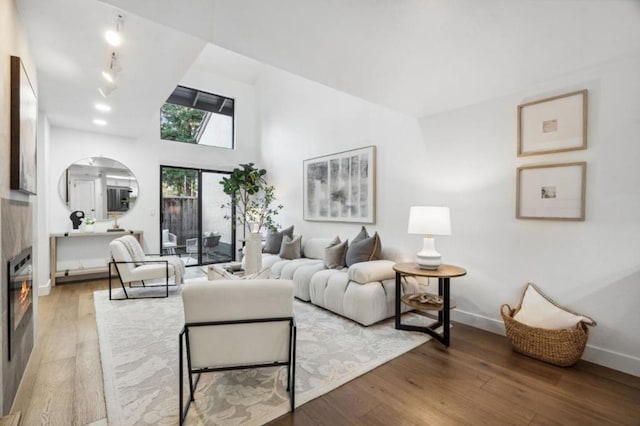 living room featuring hardwood / wood-style floors and high vaulted ceiling