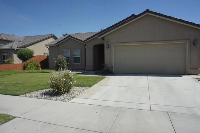 ranch-style home featuring a garage and a front lawn