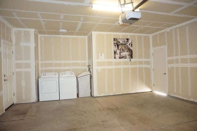 garage with a garage door opener and washer and clothes dryer