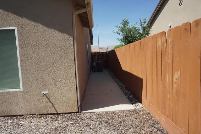 view of side of home featuring central AC unit