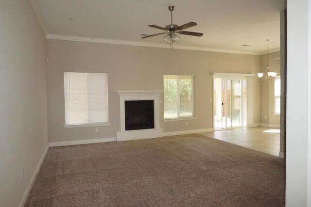 unfurnished living room featuring crown molding, carpet floors, and a wealth of natural light