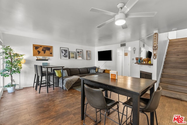 dining room with dark hardwood / wood-style flooring and ceiling fan