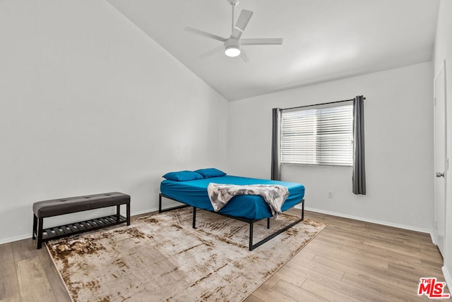 bedroom featuring lofted ceiling, ceiling fan, and light hardwood / wood-style floors