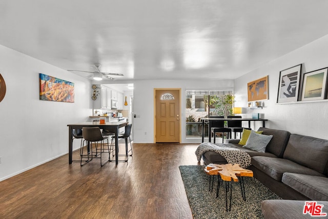 living room with dark hardwood / wood-style floors and ceiling fan