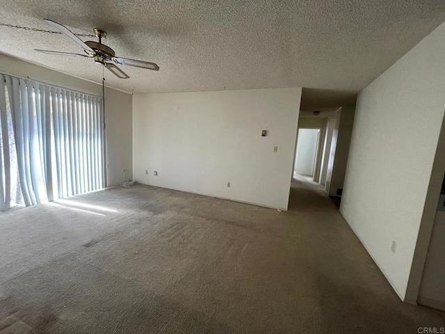 empty room featuring carpet, a textured ceiling, and ceiling fan