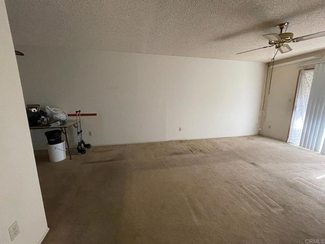 carpeted empty room with a textured ceiling and ceiling fan