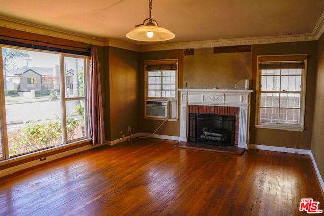 unfurnished living room with cooling unit, a healthy amount of sunlight, dark wood-type flooring, and a brick fireplace