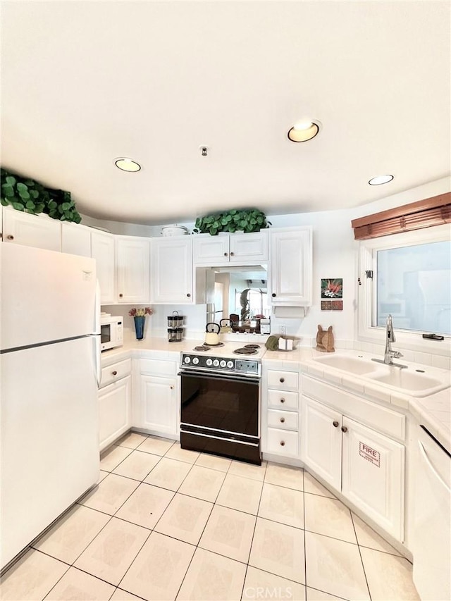 30 Camino De Flores Unit 71, Avalon, CA 90704 - kitchen featuring white appliances, white cabinets, light tile patterned floors, recessed lighting, and tile countertops