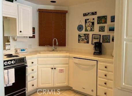 30 Camino De Flores Unit 71, Avalon, CA 90704 - kitchen with stove, dishwasher, tile counters, and white cabinetry