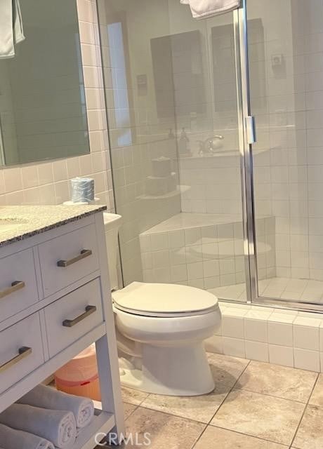 30 Camino De Flores Unit 71, Avalon, CA 90704 - bathroom with tile patterned flooring, vanity, a stall shower, and tile walls
