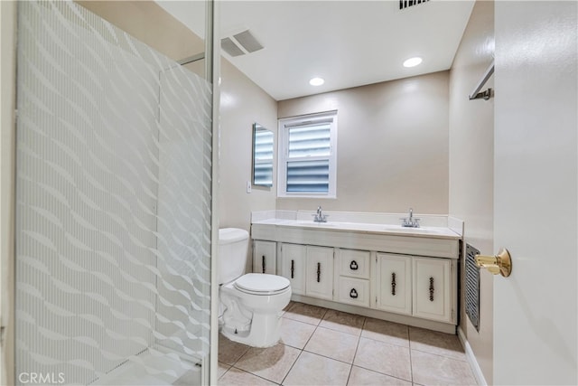 bathroom featuring tile patterned flooring, vanity, and toilet