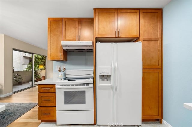 kitchen featuring white appliances and light hardwood / wood-style floors